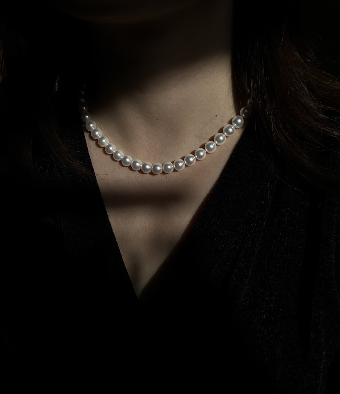 A strand of golden Akoya pearls with a gold bow clasp — the original Revelin necklace